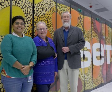 Joe Pawsey's son, Hastings, and daughter-in-law, Liz, with Aditi, Pawsey's Marketing and Events Manager, in front of Setonix, the flagship supercomputer at the Pawsey Supercomputing Research Centre